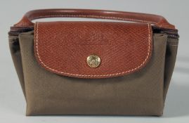 A LONGCHAMP FOLDING BROWN BAG with two leather handles.