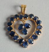 AN 18CT GOLD AND SAPPHIRE HEART PENDANT.