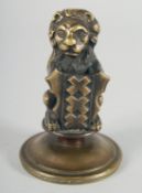 A SMALL HEAVY BRONZE HERALDIC LION on a circular base. 4ins high.