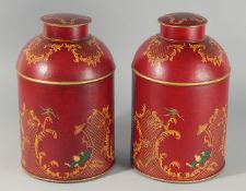 A PAIR OF CHINESE DESIGN RED TOLEWARE TINS AND COVERS. 14.5ins high.
