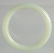 A PALE GREEN JADE BANGLE.