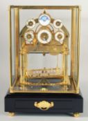 A GOOD MOONPHASE CONGREAVE ROLLING BALL CLOCK in a glass case. 12ins high.