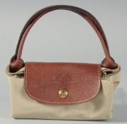 A LONGCHAMP BEIGE AND BROWN LEATHER BAG with two handles. 12ins long, 8ins deep.