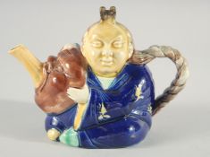 A MAJOLICA PORCELAIN TEA POT AS A CHINESE MAN. 6ins high.