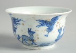 A SMALL CHINESE BLUE AND WHITE BOWL decorated with deer. 3.5ins diameter.