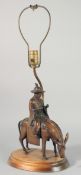 A CHINESE BRONZE MAN ON A HORSE as a lamp, on a wooden base.