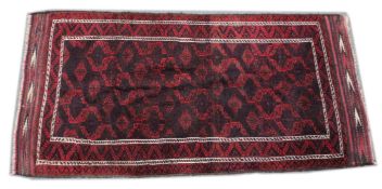 A PERSIAN RUG, deep red ground with geometric design. .6ft 3ins x 3ft 1in