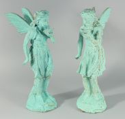 A PAIR OF IRON FAIRIES. 19.5ins high.