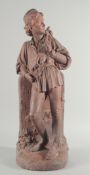L. B. BIRCH. S 1873. A GOOD LARGE TERRACOTTA FIGURE OF DICK WHITTINGTON standing beside a road