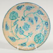 AN EARLY BLUE GLAZED CIRCULAR PERSIAN POTTERY DISH. 9ins diameter.