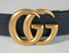 A LONG BLACK LEATHER GUCCI BELT.