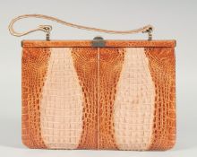 A 1940's - 1950's TWO COLOUR CROCODILE SKIN HANDBAG with raised skin, iron mount, fitted interior