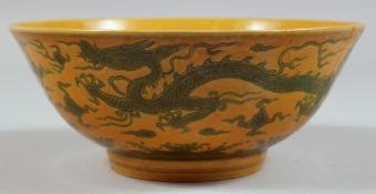 A LARGE CHINESE FAMILLE JAUNE CIRCULAR PORCELAIN BOWL (A/F). 7ins diameter.