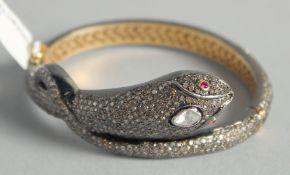 A SUPERB DIAMOND SET SNAKE BANGLE.