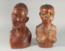 A PAIR OF CARVED WOOD AFRICAN BUSTS.
