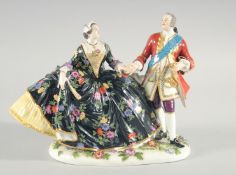 A GOOD MEISSEN PORCELAIN GROUP OF A GENTLEMAN AND A LADY in rich costume painted and encrusted