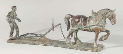 A BRONZE GROUP. A MAN PLOUGHING with a horse. 18ins long.