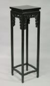 A CHINESE TALL EBONY WOOD STAND with carved frieze. 3ft 9ins high x 1ft 1.5ins