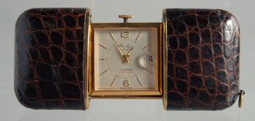 A FOLDING LEATHER CASED GOLFER WATCH by Bulgari, Geneva.