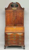 A GEORGE III MAHOGANY BUREAU CUPBOARD BOOKCASE, AMERICAN, with a swan neck pediment having an