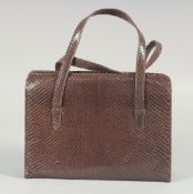 A 1940's - 1950's BROWN SNAKESKIN HANDBAG, folding interior with two snakeskin handles. 6.75ins