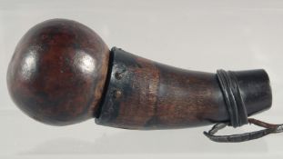 A TRIBAL WOODEN SNUFF BOTTLE. 5ins long.