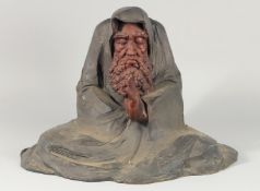 A LARGE ABSTRACT BRONZE OF A MAN PRAYING. 13ins high.