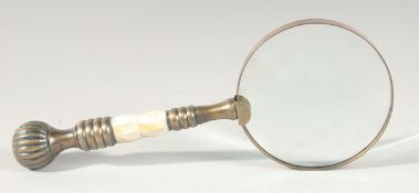 A MAGNIFYING GLASS with brass handle.