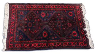 A PERSIAN DESIGN CARPET, dark blue ground with two large central medallions. 6ft 6ins x4ft 4ins.