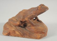 A CARVED WOOD FROG. 7ins long.