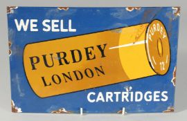 AN ENAMEL SIGN which reads ‘WE SELL PURDEY LONDON CARTRIDGES’ on a shotgun shell. 12ins x 8ins.