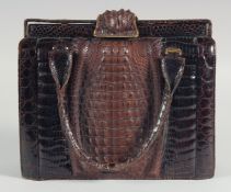 A 1940 - 1950 BLACK AND BROWN CROCODILE SKIN HANDBAG with a strip of brown crocodile skin on a black