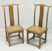 A PAIR OF CHINESE YOKE BACK CHAIRS with wicker panel seats.
