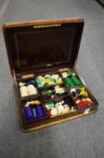 A good French kingwood and brass inlaid box containing numerous gaming chips.