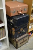 Four large suitcases/trunks.