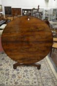 A Regency rosewood circular tilt top breakfast table on circular column support with concave sided
