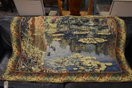 A modern machine-made tapestry wall hanging depicting ducks on a pond 160cm x 120cm.