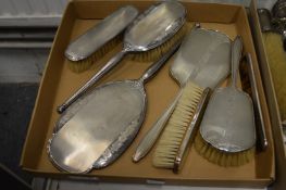 Two silver backed dressing table sets.