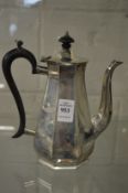 A small silver coffee pot.