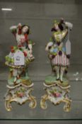 A good pair of Paris porcelain figures of young ladies with bunches of grapes.
