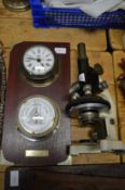A microscope and a combination barometer/clock.