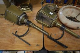 A pair of coaching lamps style light fittings.