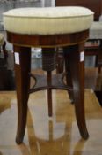 A 19th century mahogany circular revolving music seat.