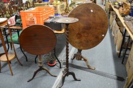 Two mahogany tripod tables and an oak torchere (faults).