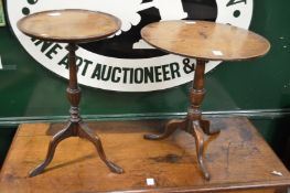 A miniature oak tilt top tripod table and a modern tripod table.