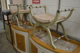 A pair of painted X-framed stools.