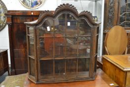 A Continental oak hanging display cabinet.