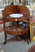 A 19th century mahogany corner washstand complete with blue and white bowl.