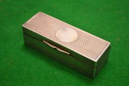 A small silver box with engraved decoration.