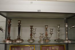 Three pairs of silver plated candlesticks and a plated candelabra.